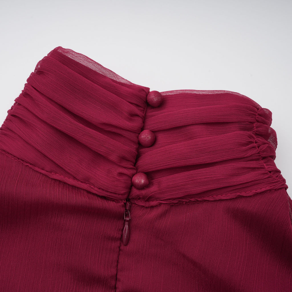 Vestido mini asimétrico de tul con volantes en color burdeos Éléna de Final Sale, muestra la silueta y detalles del diseño.