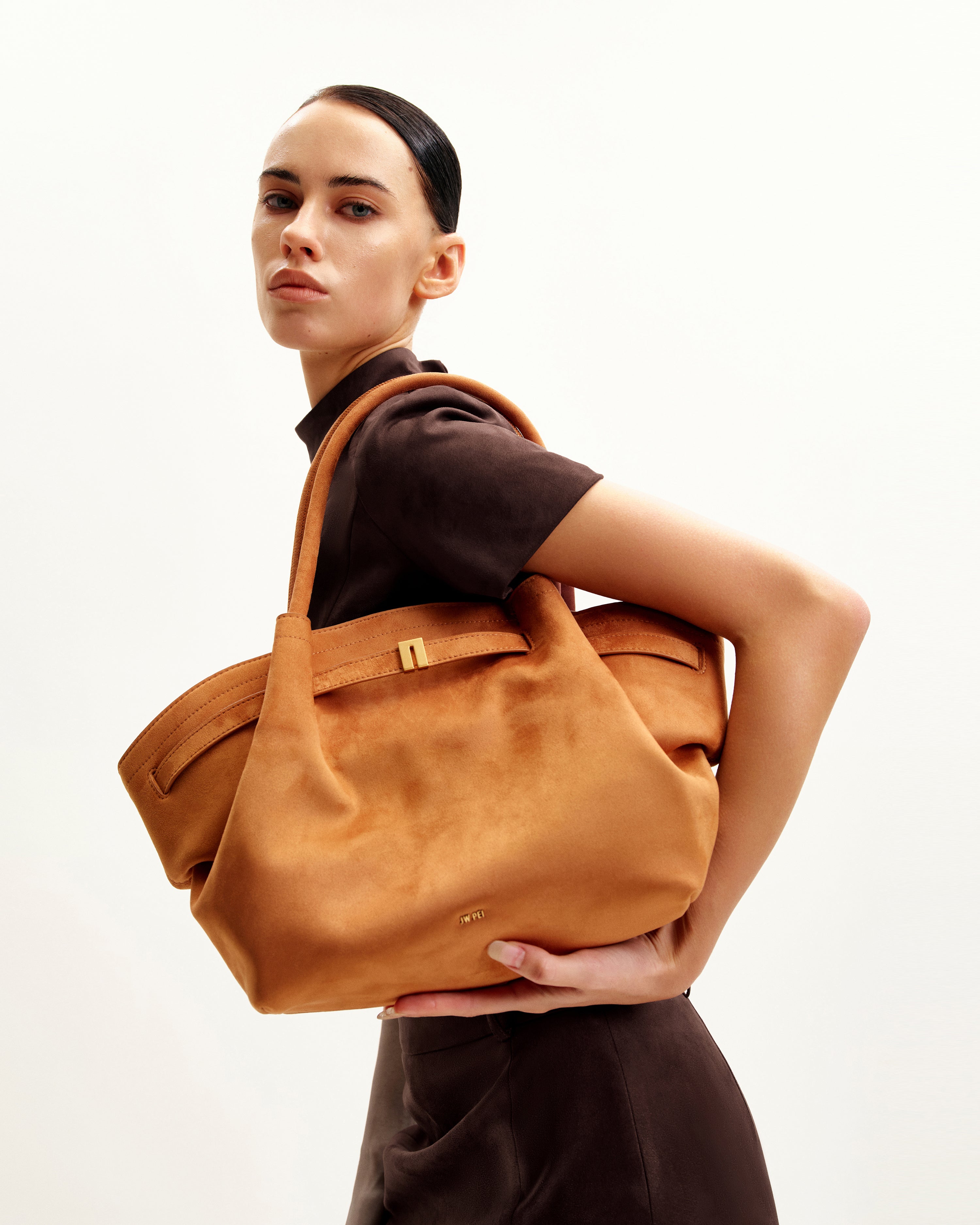 Bolso tote mediano JW PEI Hana en color neutro, con asas cortas y diseño elegante, visible en la imagen.
