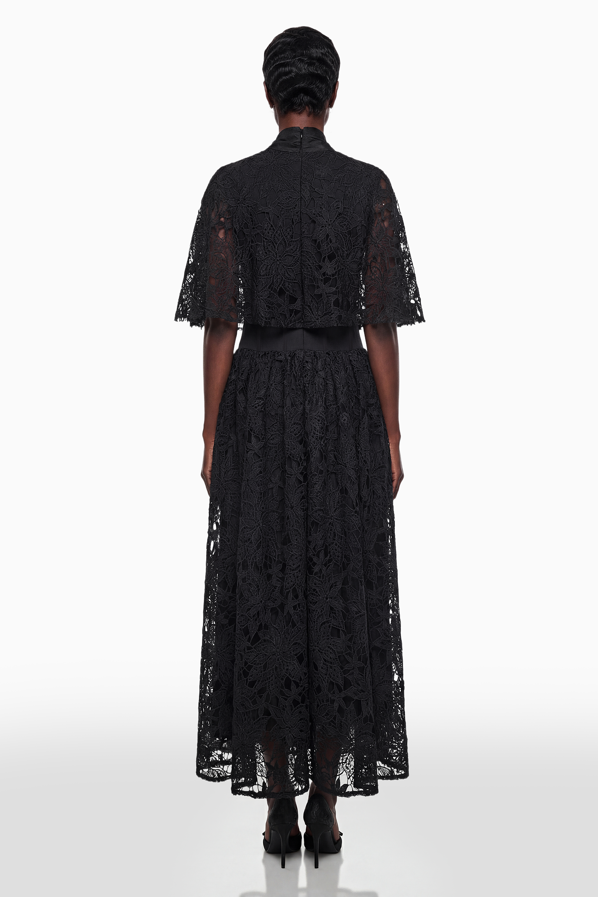 Vestido largo Sissel de encaje floral negro de MRMelbourne con lazo en la parte superior, mostrando detalle del diseño y tela.