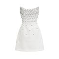 Vestido mini blanco Melisande con adornos, con detalles elegantes y ajustado, ideal para ocasiones especiales.